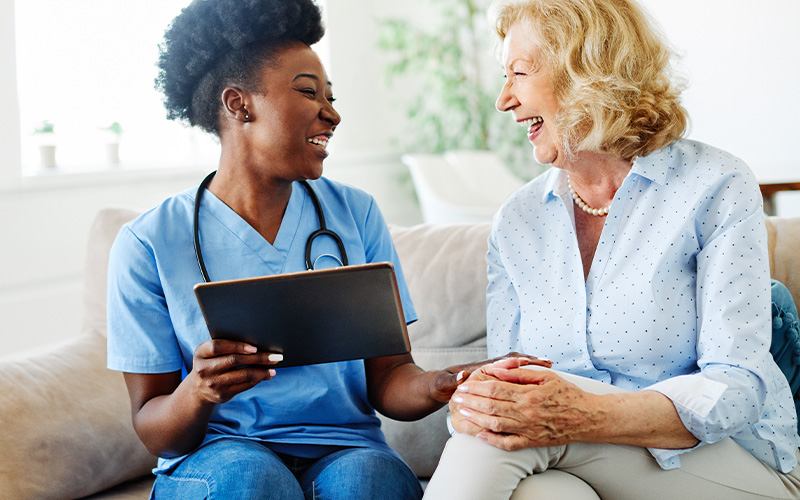 a man and woman sitting next to a laptop