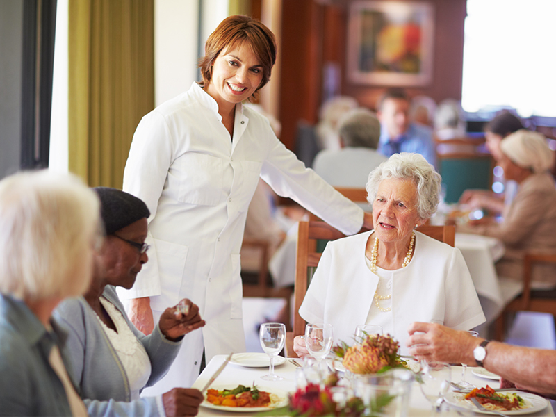 a group of people sitting at a table eating food
