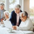 A Group Of People Sitting At A Table